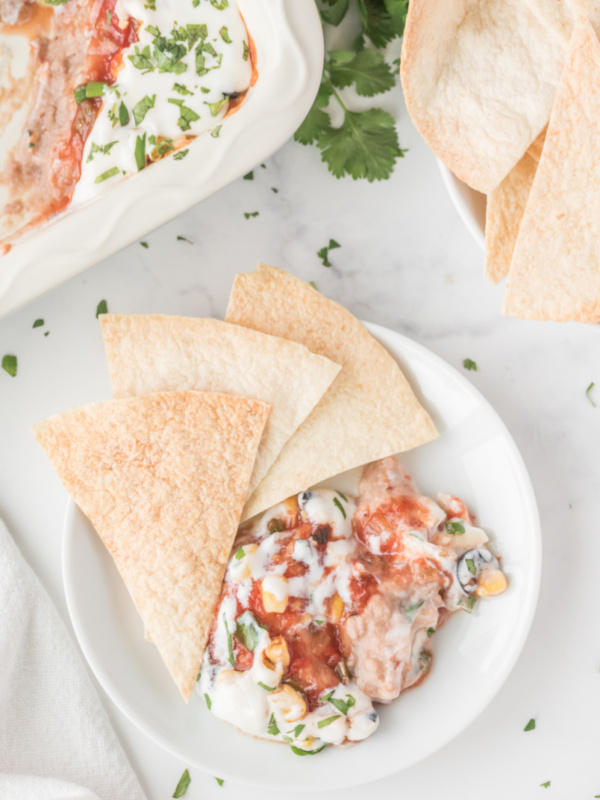 chips and party bean dip on a plate for serving