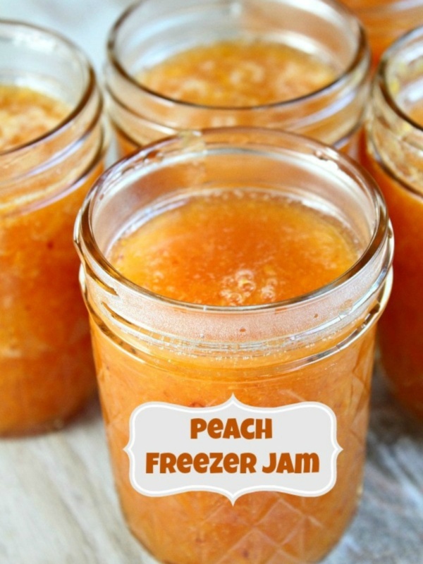 peach freezer jam with a label and several more jars of peach jam in the background.