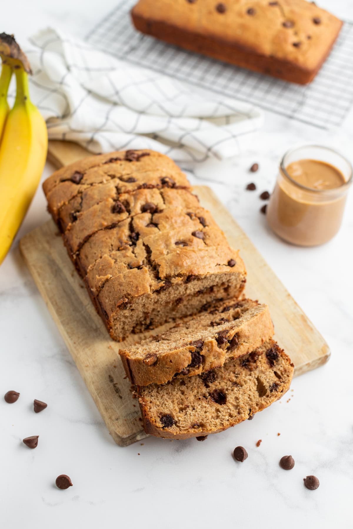 loaf of banana bread partially sliced on board