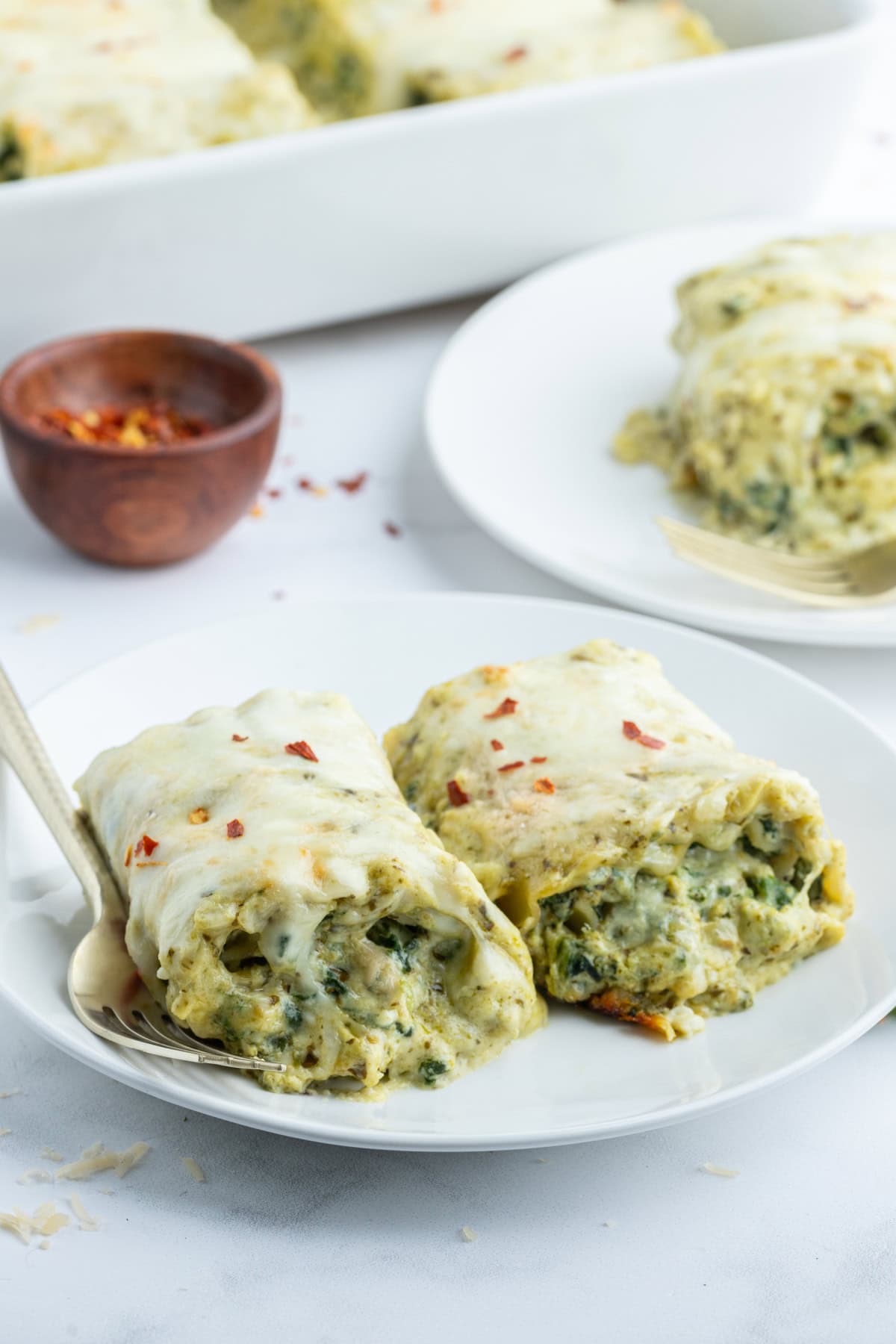 serving of pesto lasagna rolls on plate