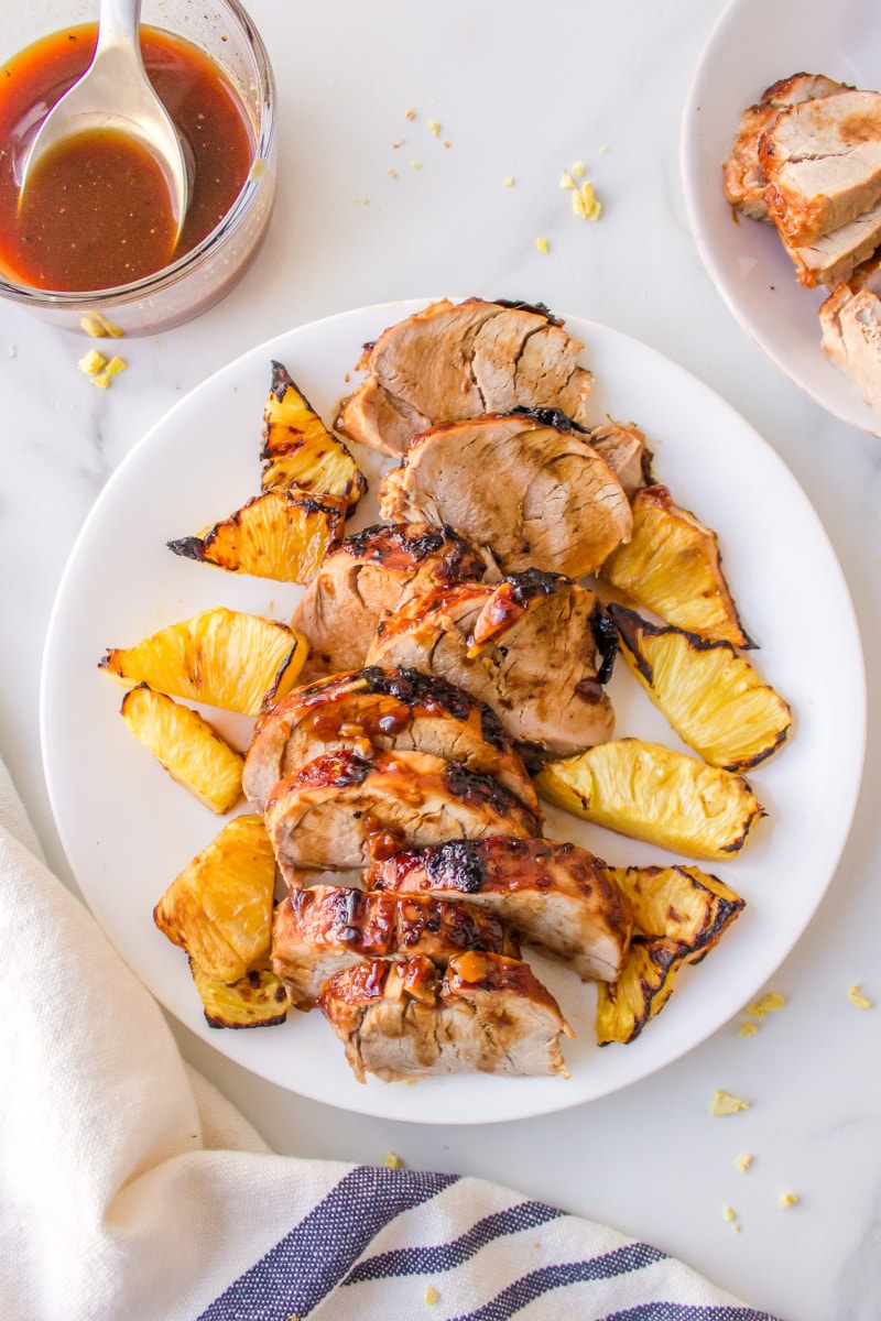 pineapple pork tenderloin on a white plate