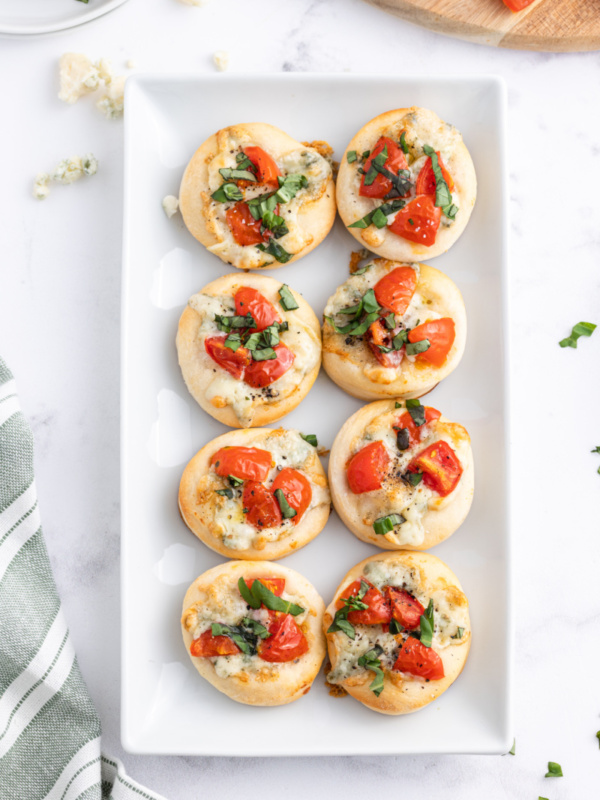 platter of pizzette with gorgonzola tomato and basil