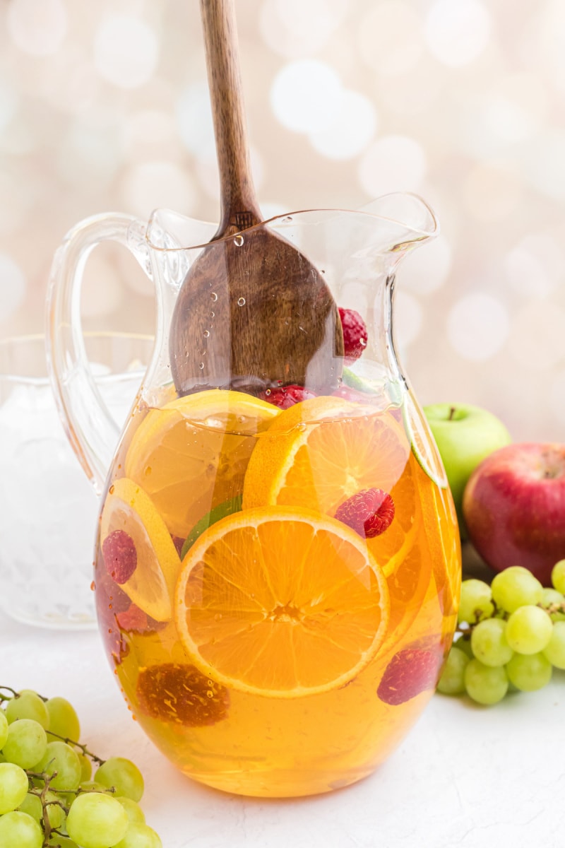 stirring sangria in a pitcher