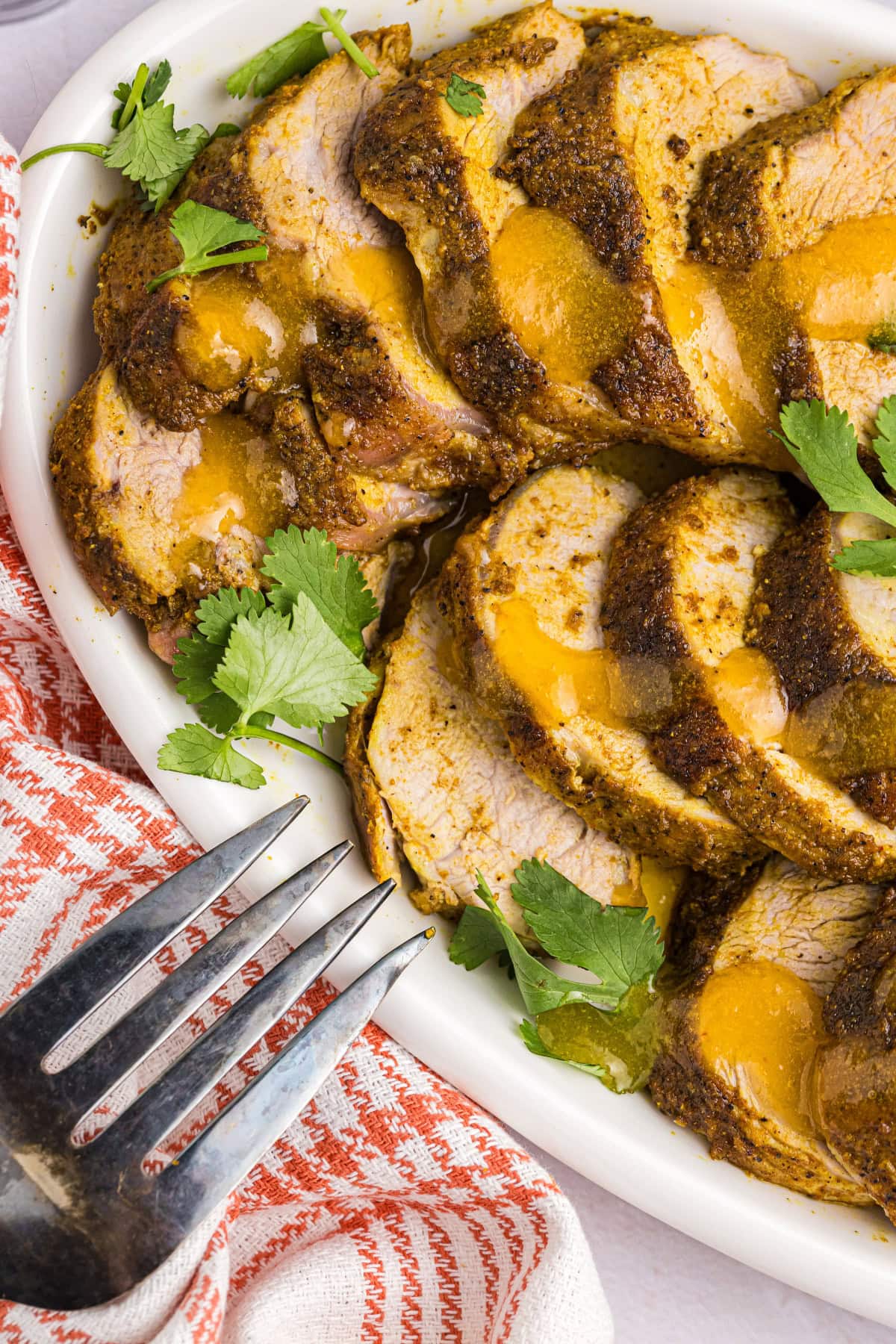 Pork tenderloin slices on plate with apricot ginger sauce