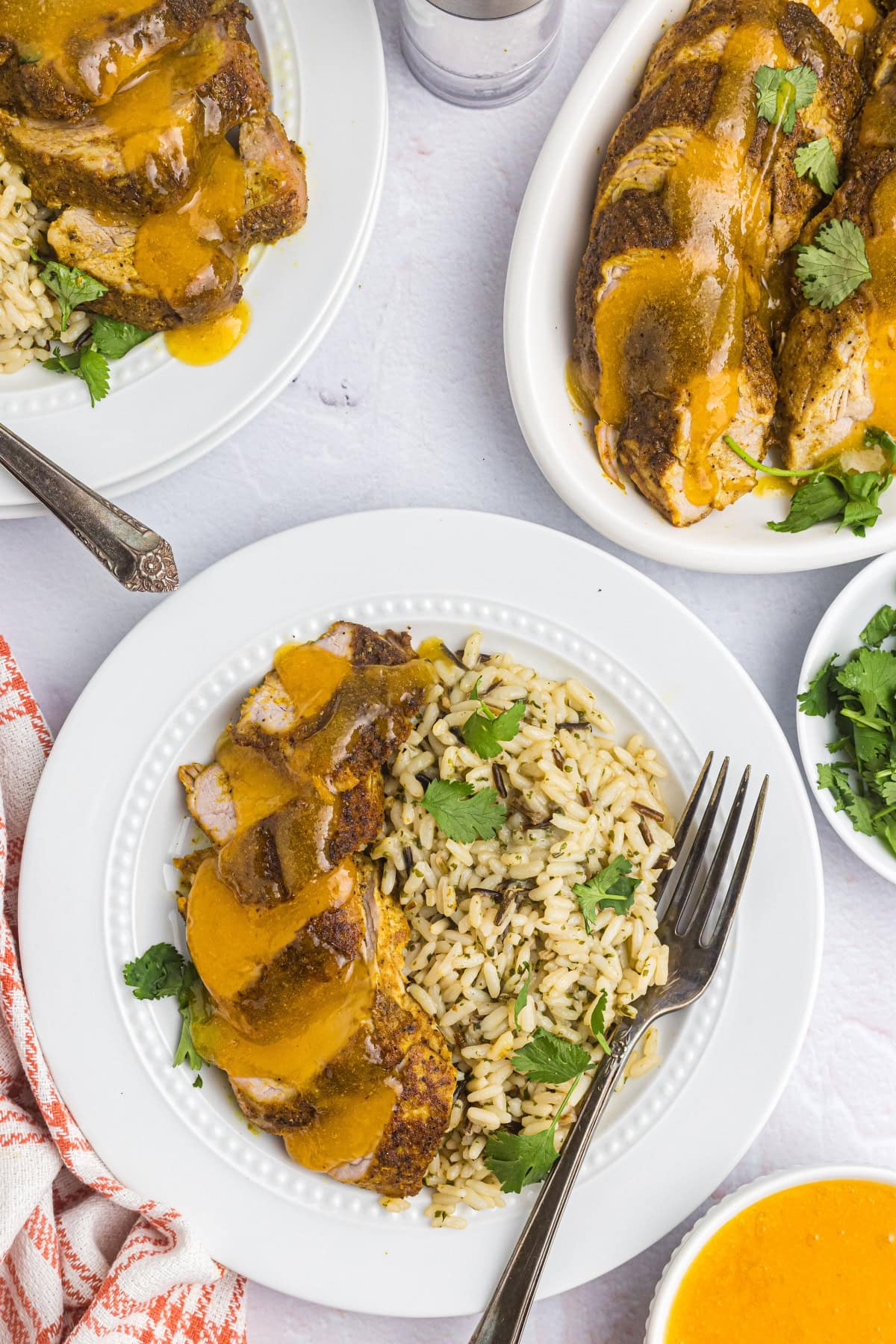 sliced pork tenderloin on plate with rice