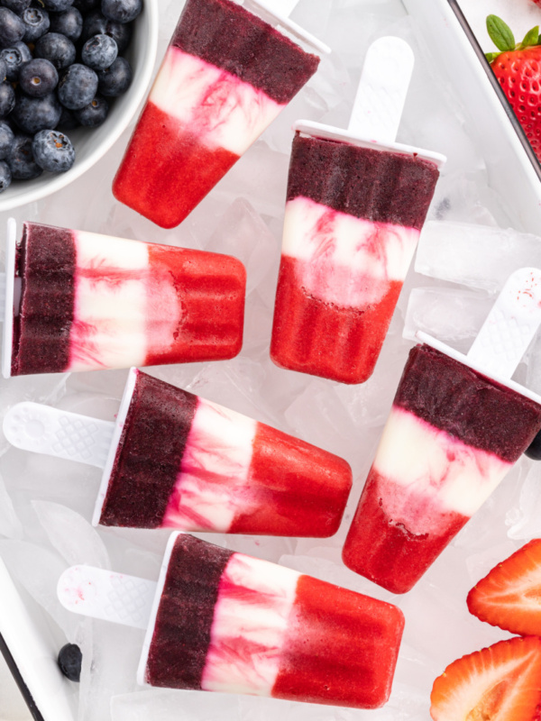 red white and blueberry popsicles over ice