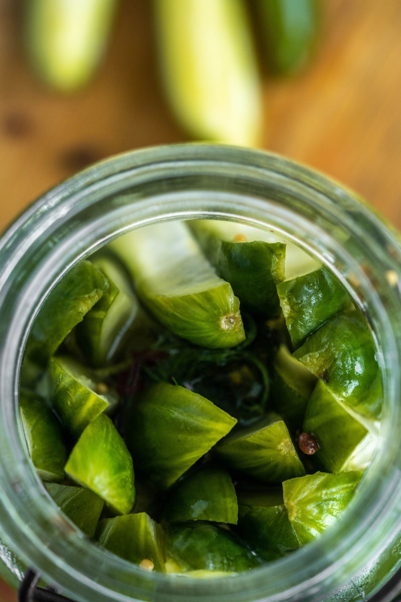 looking down on pickles in an open jar