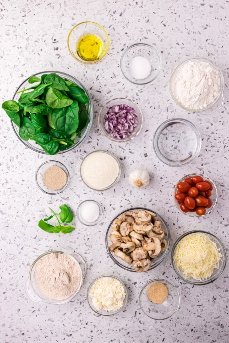 ingredients displayed for making a spinach mushroom and feta pizza