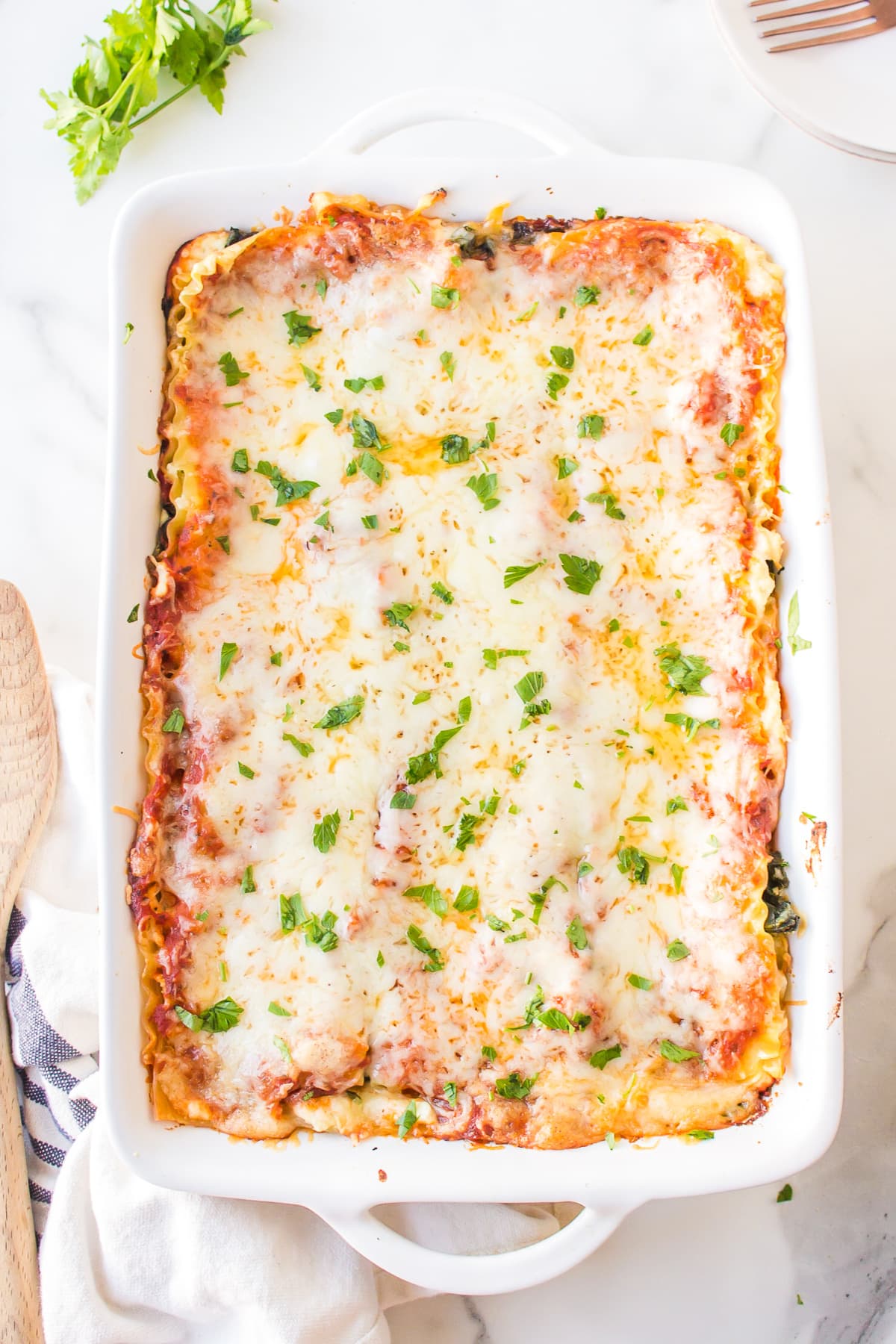 overhead shot of pan of spinach, pesto and cheese lasagna