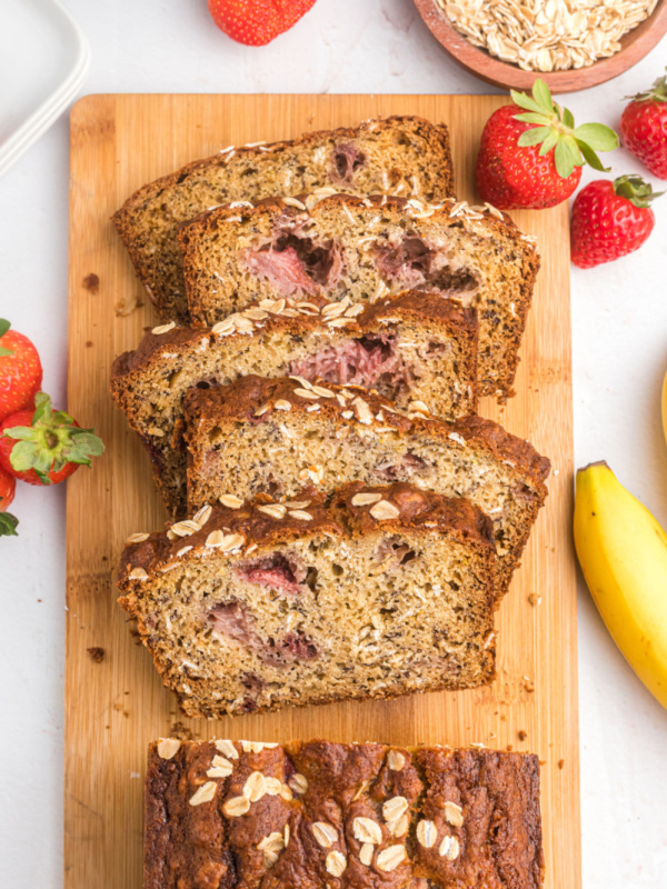 slices of strawberry oatmeal banana bread on board