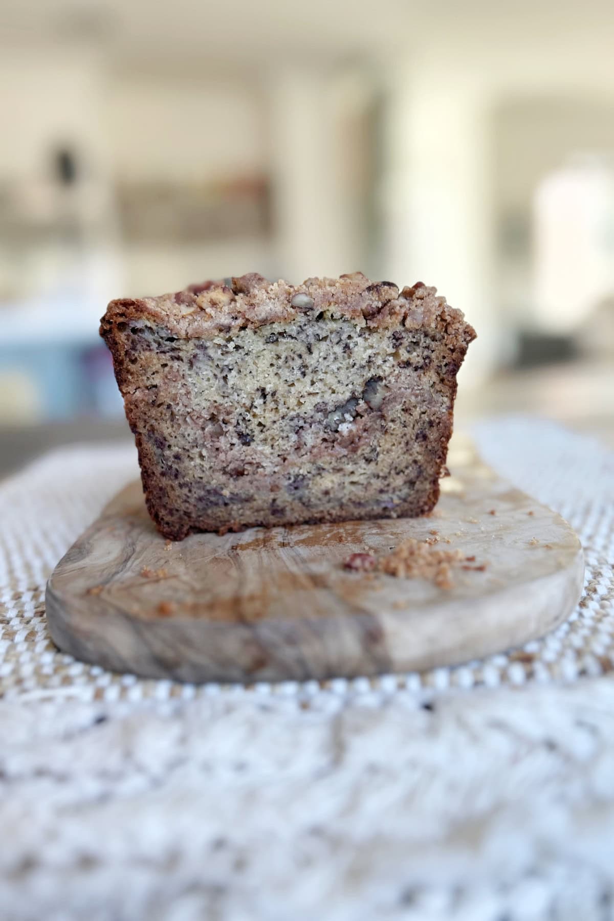 banana bread loaf sliced open to see inside and sitting on board