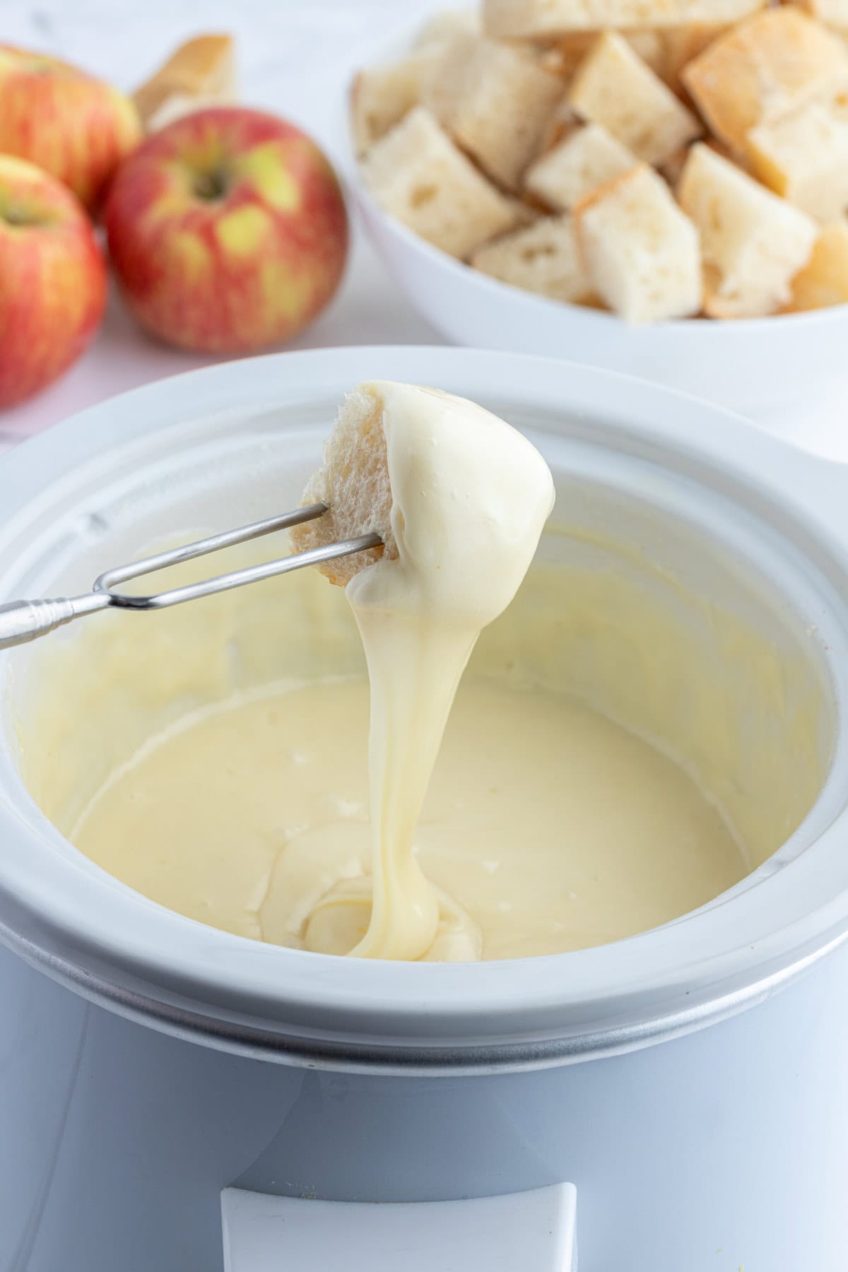 dunking bread into swiss cheese fondue