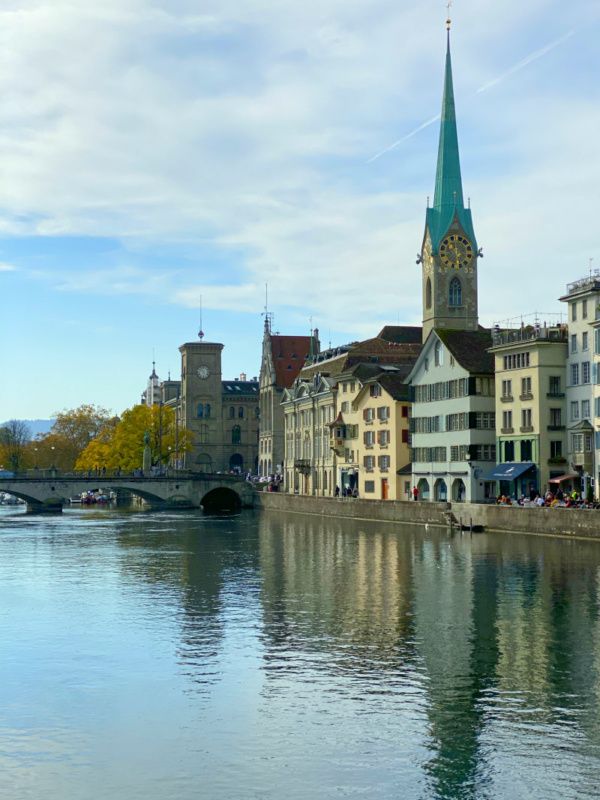 looking down the river in zurich switzerland with buildings on the side of the river