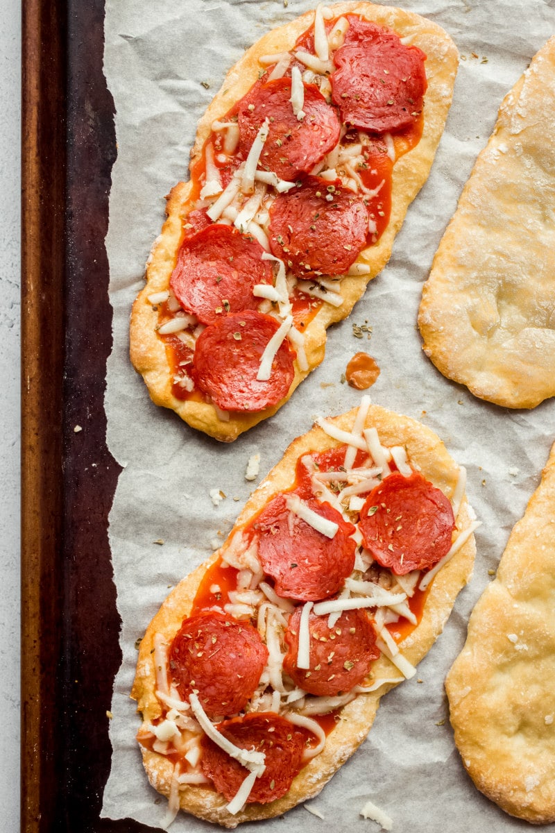 making Weight Watchers Pepperoni Pizzas on a baking sheet ready for the oven