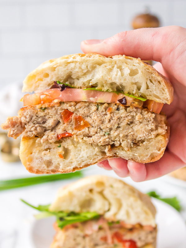 hand holding sliced open turkey white bean burger