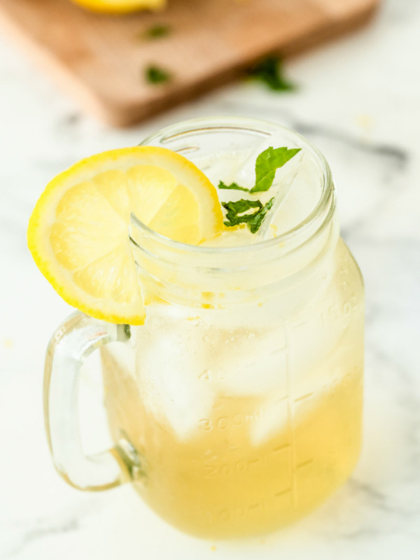 vodka lemonade in a glass mug garnished with lemon