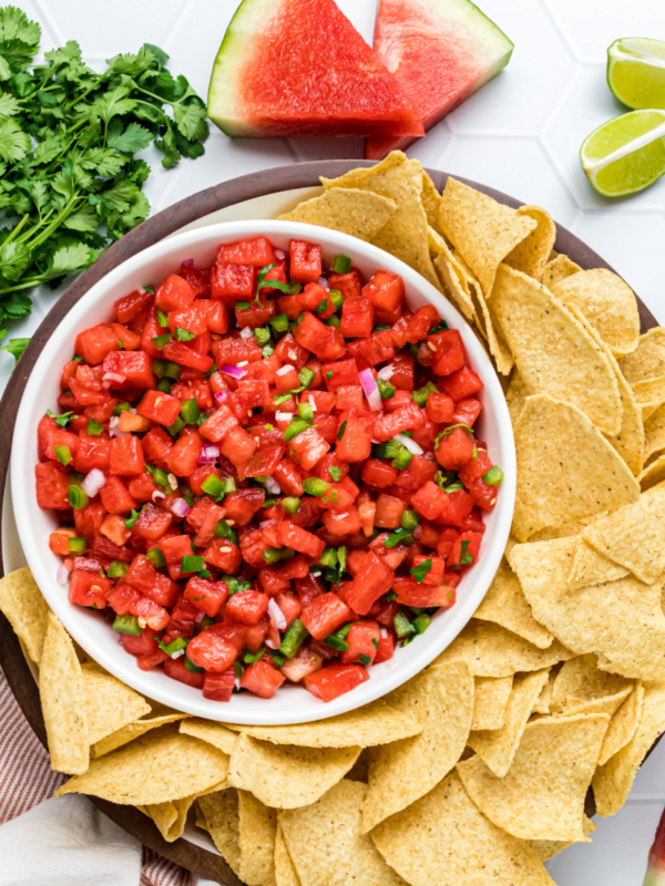 bowl of watermelon salsa with chips surrounding