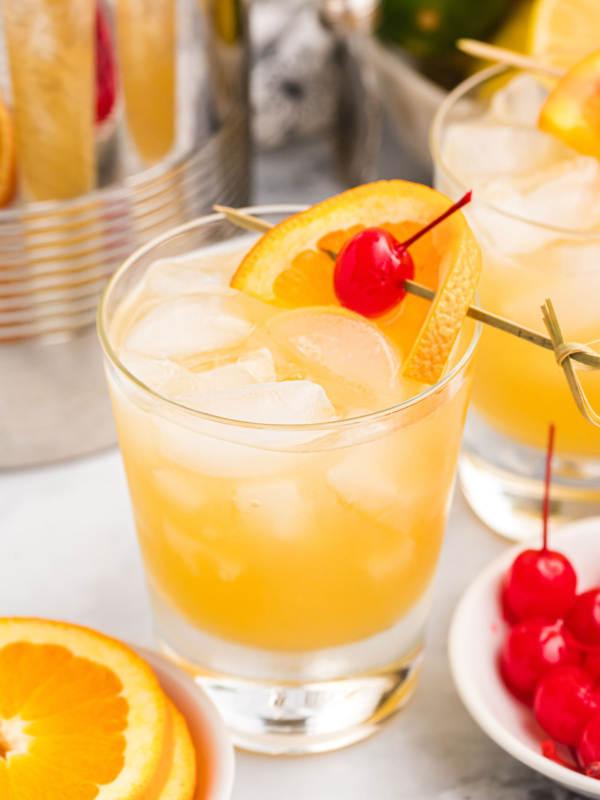 whiskey sour in a cocktail glass with garnishes