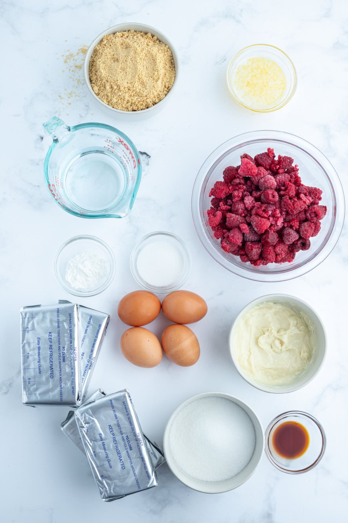 ingredients displayed for making white chocolate raspberry cheesecake