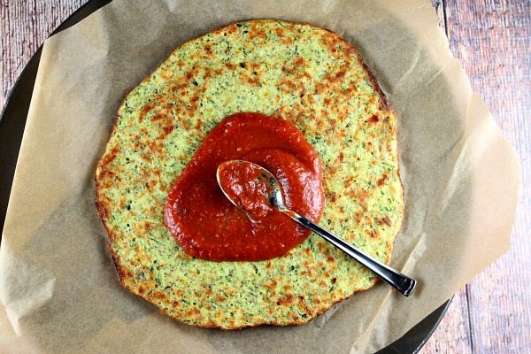 Zucchini Pizza Crust with sauce spooned on top