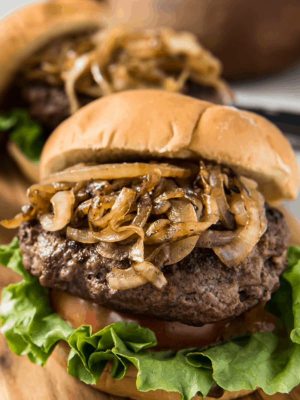 jucy lucy burger piled high with grilled onions